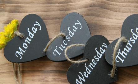 Photo of mini slate hearts with the names of days of the week written on them.