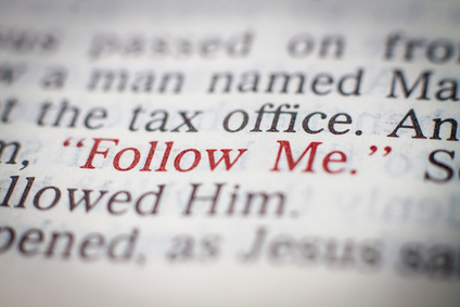 Photo of a page from the Bible with the words 'Follow me' picked out in red print.