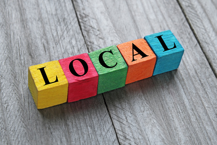 Photo of coloured wooden cubes spelling the word 'Local'.