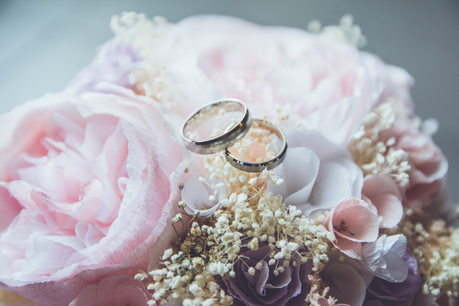 Photo of wedding rings and bouquet