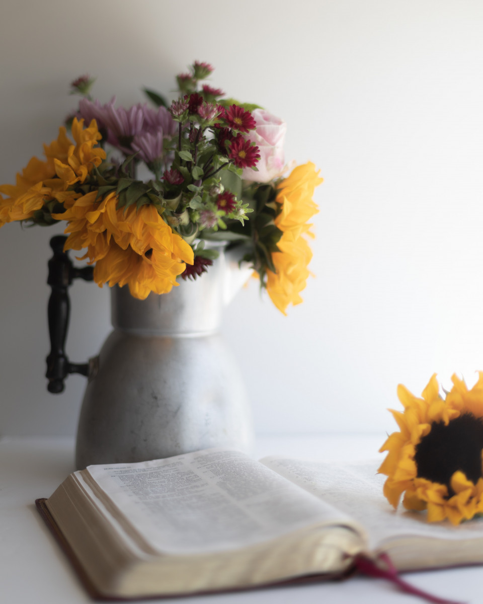 Sunflowers in a jug and a bible
