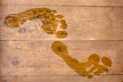 Photo of wet footprints on wooden boards