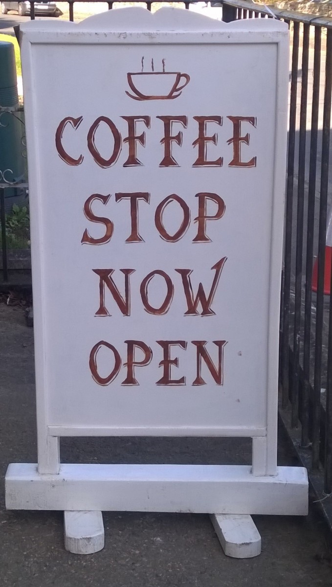 Photo of Sandwich Board showing 'Coffee Stop now open'.