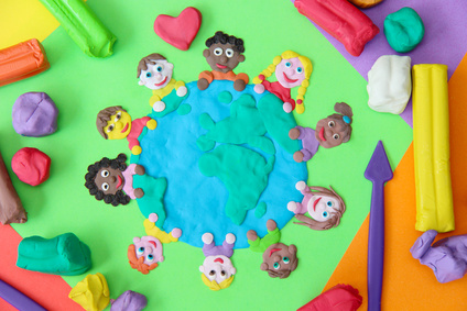 Photo of plasticine model of young children around a table.